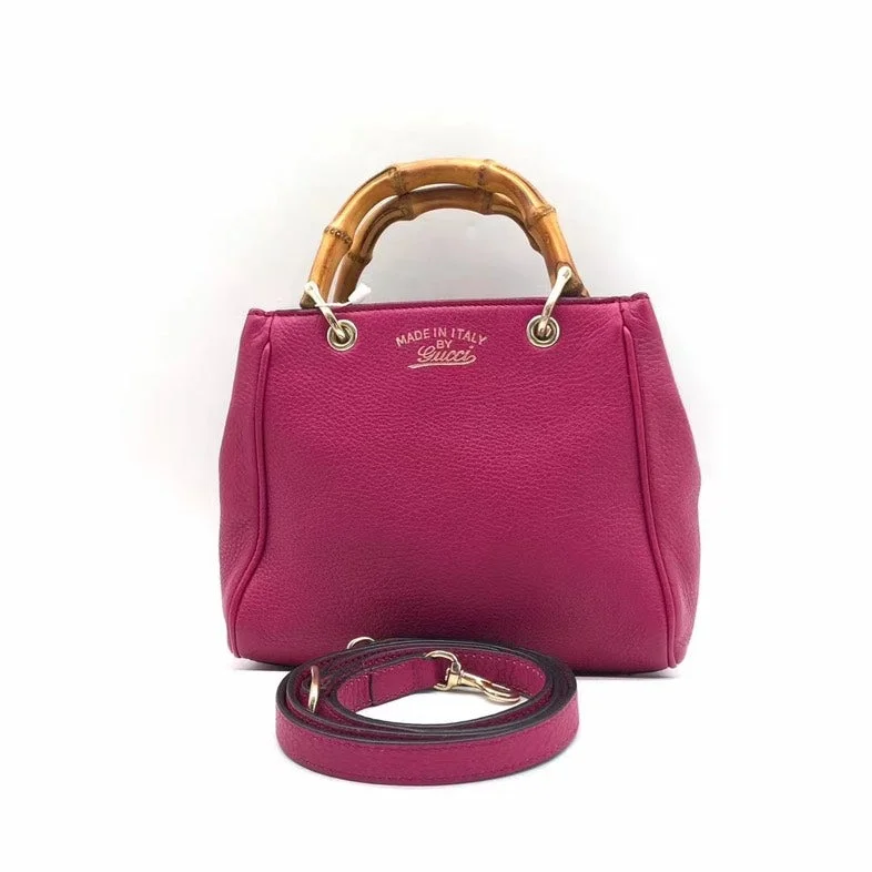 Women Gucci bags with a chain - link trim and a leather bodyWomen Gucci bags with a chain - link trim and a leather bodyGucci Bamboo Handle Two-Way Bag - Fuchsia Pink Leather Small