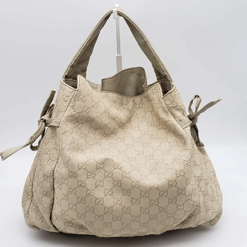 Women Gucci Sylvie bags with a leather - wrapped handleWomen Gucci Sylvie bags with a leather - wrapped handleGucci Gussissima Cream Shoulder Bag