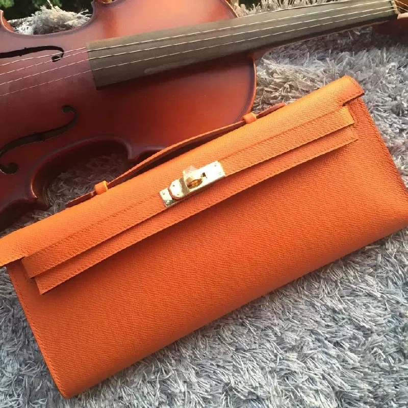 Hermès Kelly Bags with a snap - fastened front pocket for convenienceHermes Orange Handcrafted Kelly Cut Clutch